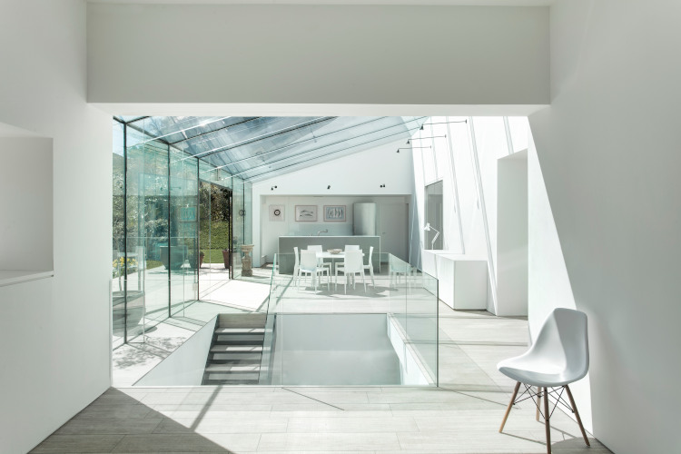White, light contemporary home with glass walls, roof and balustrade width=