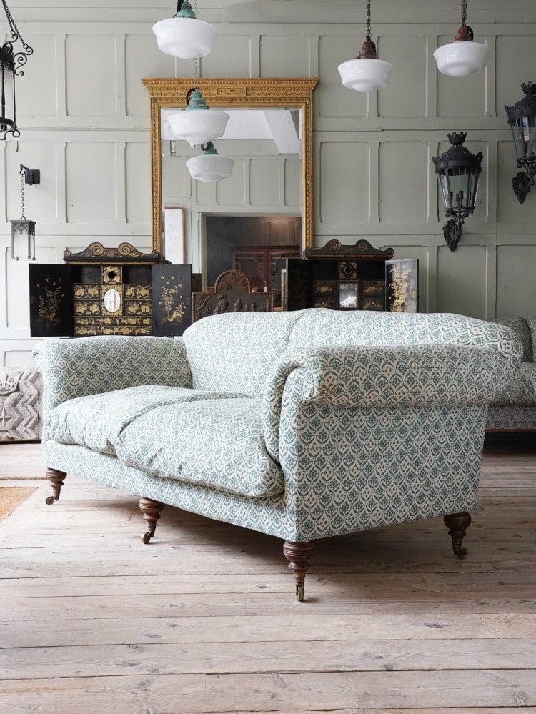 Howard and Sons Wimborne Chair - set in a beautiful historic room on bare floorboards in front of a mint green panelled wall 