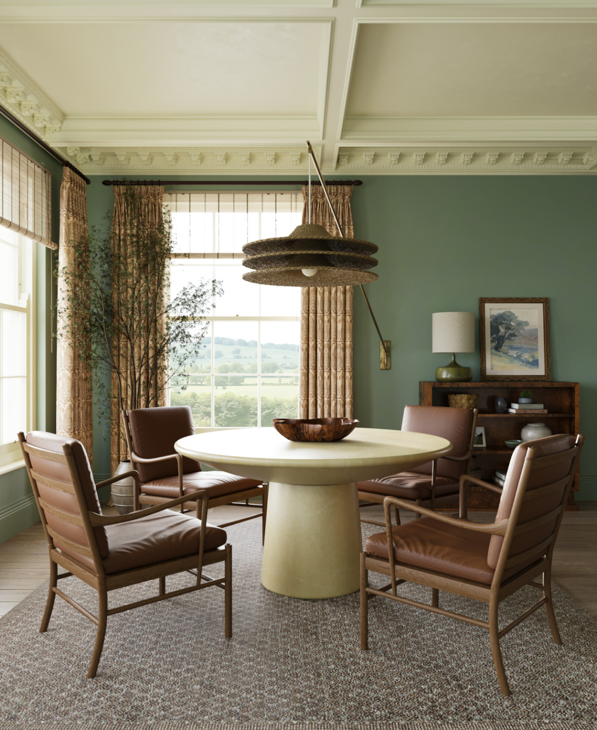 4 luxury leather chairs surround a stone circular table with a large hanging lamp is suspended from above. The olive green walls seperate large sash windows and a white panelled ceiling in the drawing room of the Sussex Estate Interior Design project.