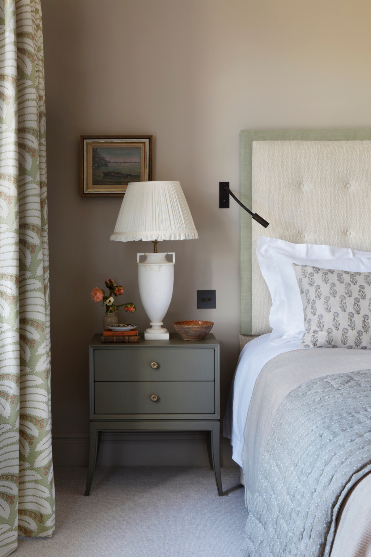 A side view of a large comfy double bed, bedside table and large vase ceramic bedside lamp as part of the bedrooms in the West Sussex House interior design project.