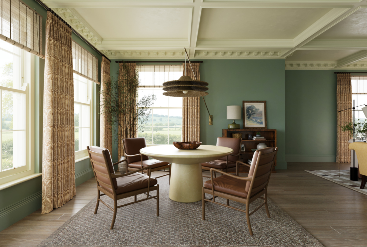 The hero image for the Sussex Estate Interior Design Project from Studio Hooton of Mayfair. An elegant dining room with round table, four leather dining chairs, large windows with patterned curtains, green walls, statement pendant light, and countryside views creating a modern yet traditional English country house design.