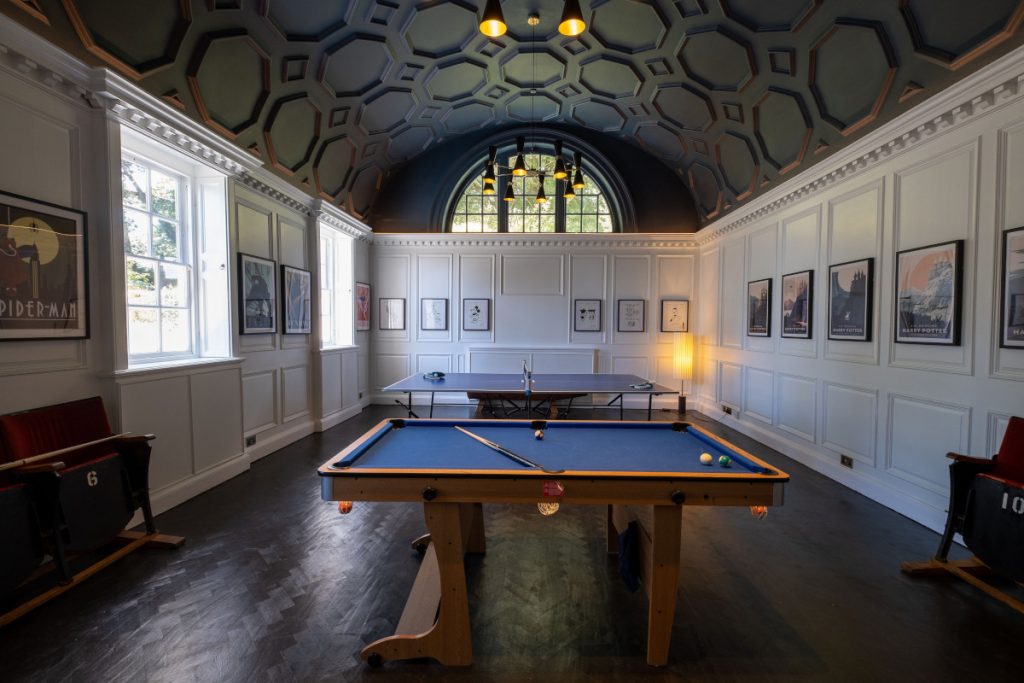 Luxurious games room wuth a vaulted ceiling, billiards table, table tennis table at Fowey Hall in Cornwall.