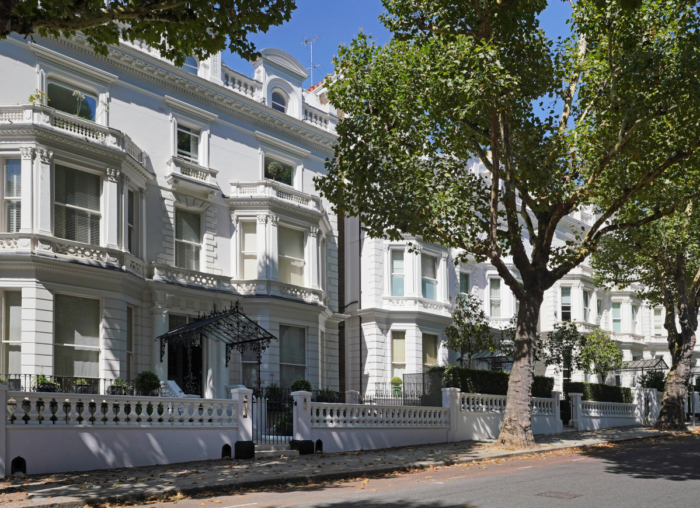 An example of a super prime interior design showing a large white villa in Holland Park, London with a large green tree to the right.